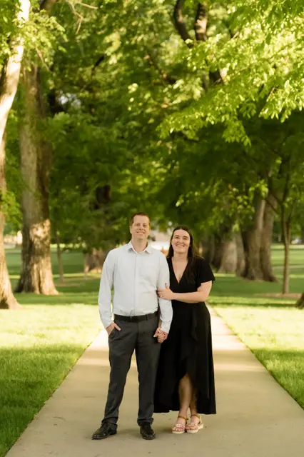 Standing together on the sunlit path beneath the elms