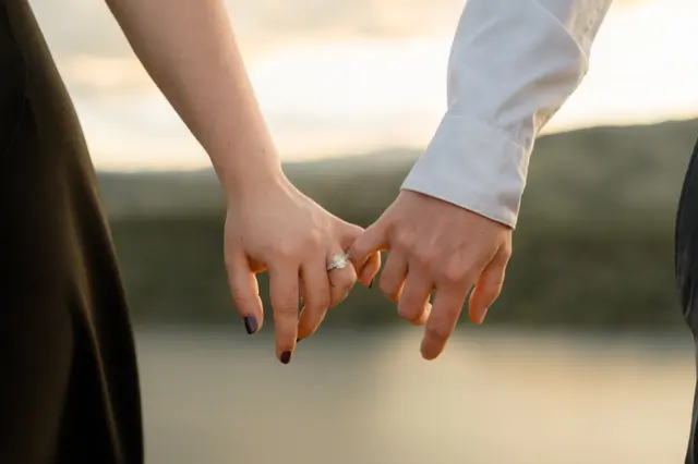Pinkies linked at sunset