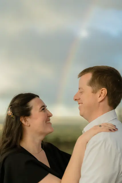 Face to face with a rainbow behind them