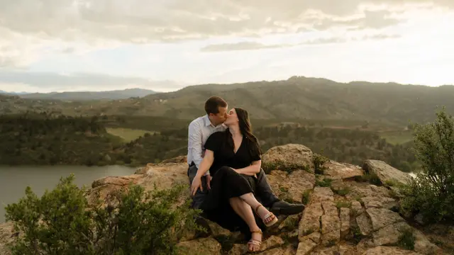 A kiss on the rocks with the reservoir spread out behind
