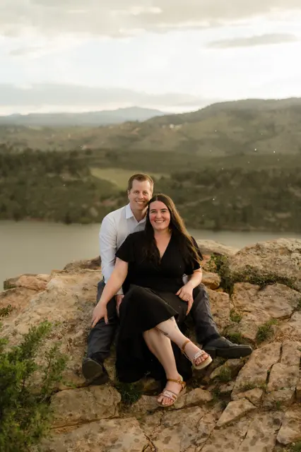 Sitting together on the sunset rocks above the water