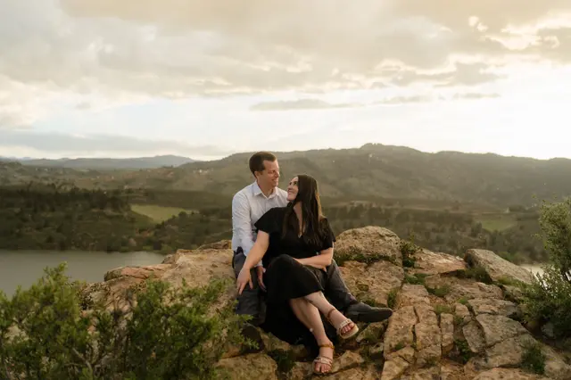 Sitting close on the rocks with the reservoir and foothills behind