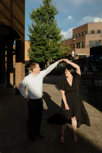 Evan twirling Brianna in golden evening light downtown