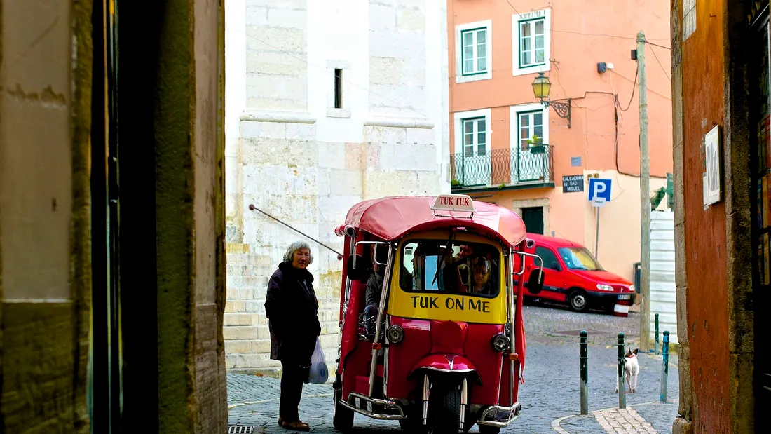 A tuk-tuk waiting on a narrow street in Alfama, Lisbon