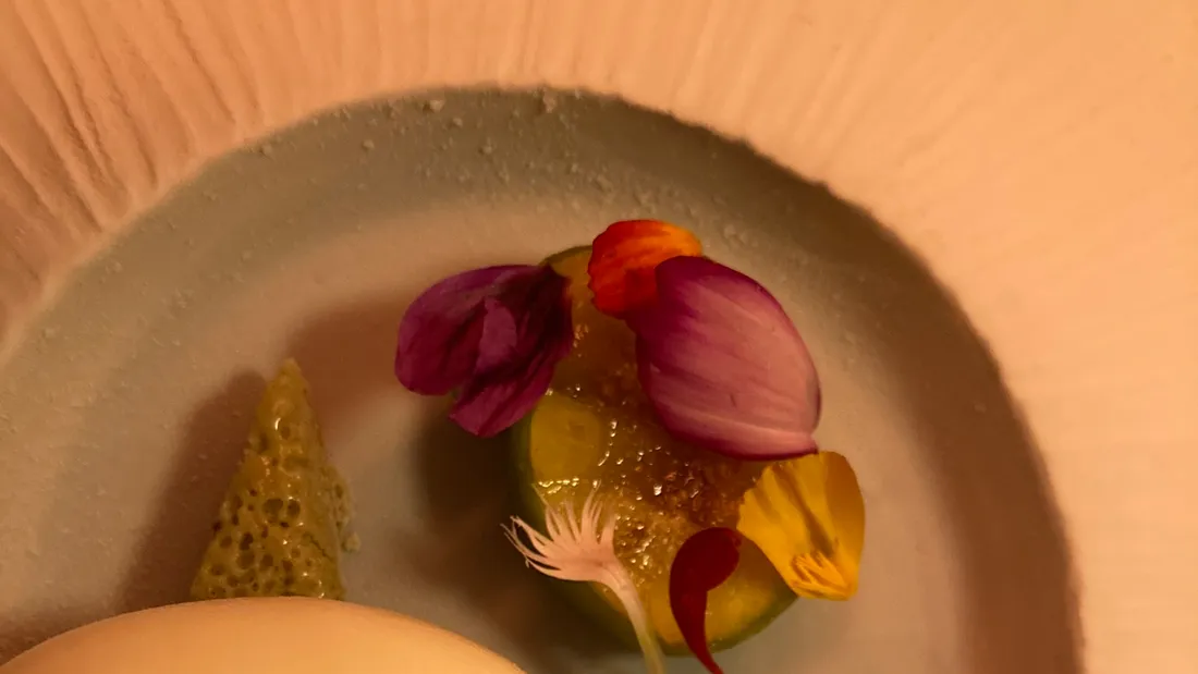 A tasting-menu course scattered with edible flowers