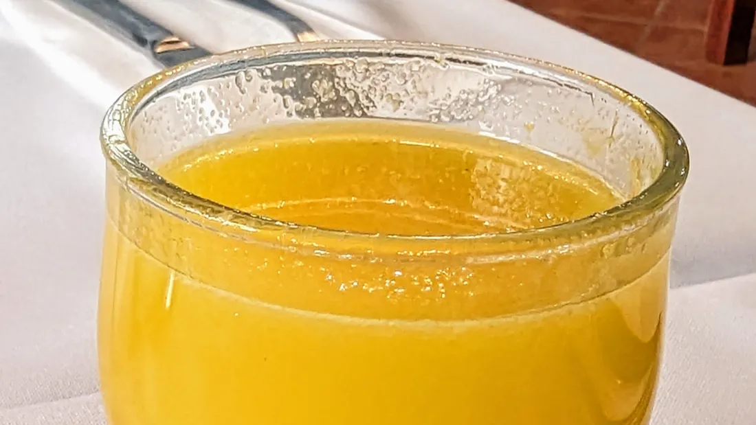 A glass of poncha, Madeira's sugarcane rum, honey, and lemon drink