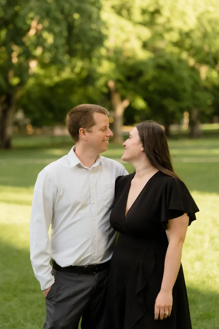 Brianna smiling up at Evan on a shaded green lawn